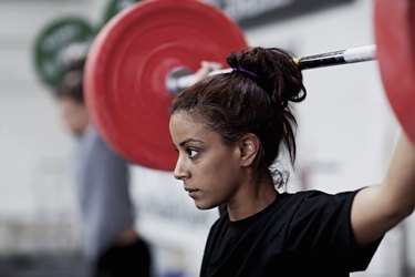 Young woman training with weights