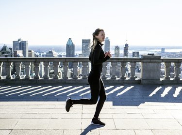 Caucasian woman running in city