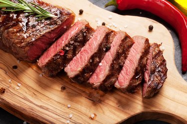 Grilled striploin steak on cutting board for muscle building diet