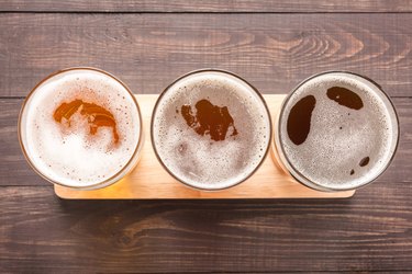 Assortment of beer glasses on a wooden background. Top view