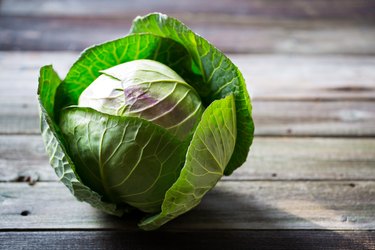 Fresh green garden cabbage on rustic wooden background