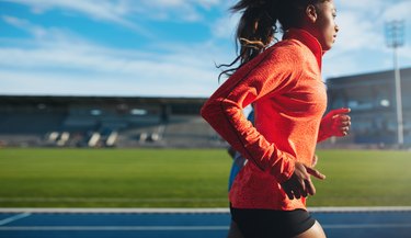 African female athlete training on race track