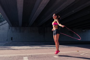 Fit woman runner warming up outdoors