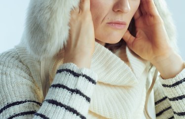 Closeup on stressed woman against winter light blue background