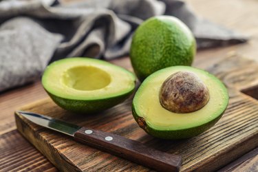 Fresh omega-6-rich avocado on cutting board