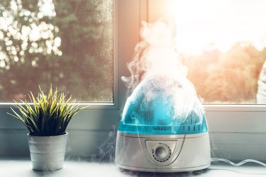 An air humidifier running on a windowsill, as a natural remedy for cough