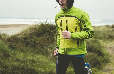 Man running in the rain on the beach