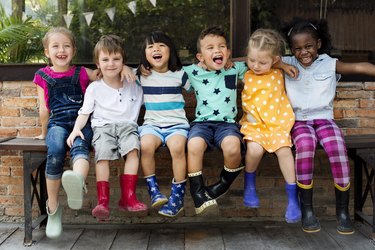 Children with arms around each other smiling