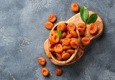 Dried apricots on gray background. Copy space for text. Top view.