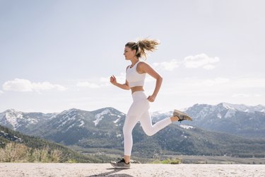 Young woman running in mountain setting