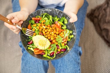 top view of a bowl of salad with chickpeas and avocado to represent foods for healthy weight gain