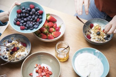 Top view of women sharing breakfast at kitchen table.