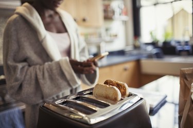 A woman making toast in her kitchen