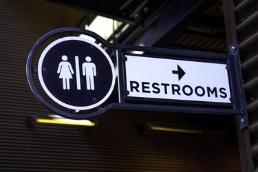 A close-up view of a restroom sign