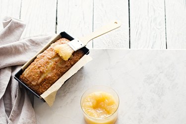 Glazed applesauce oatmeal bread on a white marble table