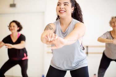 Female students learning fitness dance in a class