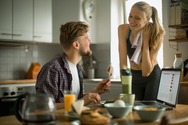 Young couple having breakfast before working out