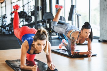 Women performing glute kickbacks.