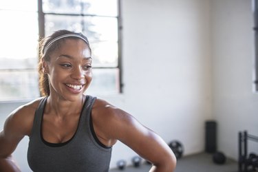 Multi-ethnic group of people smiling on gym floor after work out