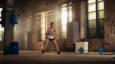 Fit Athletic Woman Does Footwork Running Drill in a Deserted Factory Remodeled into Gym. Cross Fitness Exercise/ Workout Aimed at Strengthening Legs, Enhancing Her Agility and Speed.