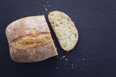 Loaf of white bread on black background to show what is bland food