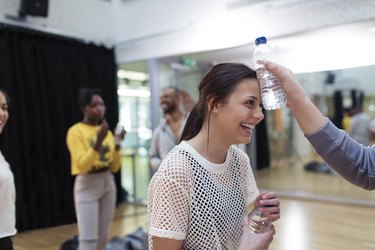 Young fitness teen holding water bottle after running exercise