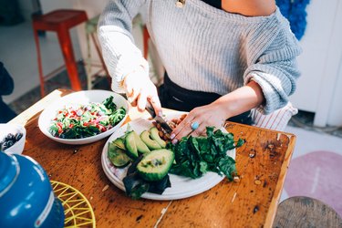 Woman knows how to get more fiber in diet by making salad
