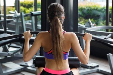 Woman doing exercise for her back - Lat pulldown