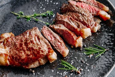 Grilled sliced ​​beef steak with rosemary close up