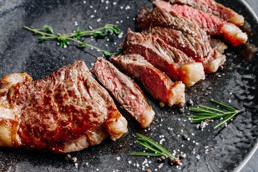 Grilled sliced ??beef steak with rosemary close up