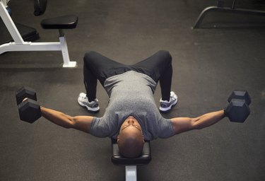Man doing a chest fly with dumbbells during an upper-body superset workout