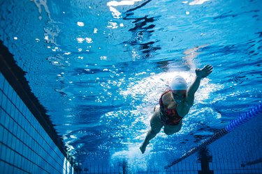 Fit female athlete swimming in pool