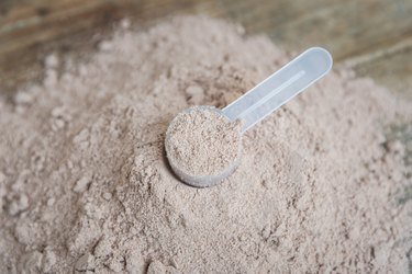 Double chocolate whey protein powder scoop nutrition healthy food bodybuilding.