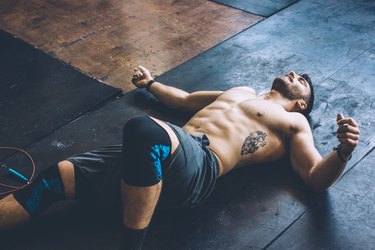 Man lying on the floor after leg day workout
