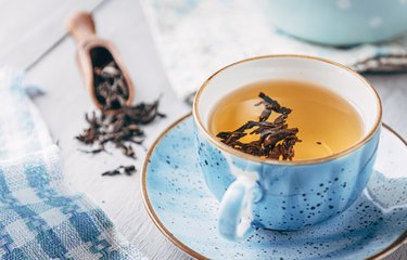 Cup of black tea on table