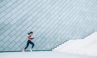 Woman is running on the city stairs