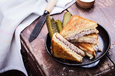 Homemade tuna melt sandwich served warm with pickles