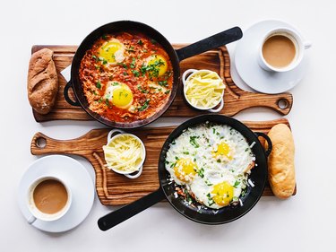 Flat lay with fried eggs in a skillet served on the table for two persons
