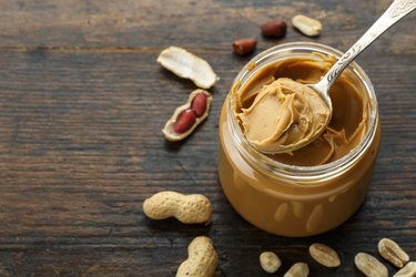 molybdenum-rich peanut butter in an open jar and peanuts