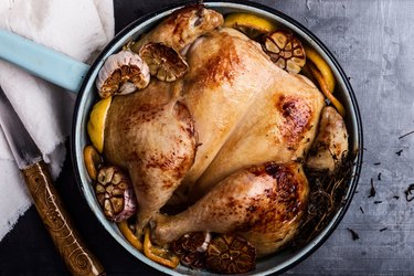 Homemade roasted chicken with spices, thyme and lemon