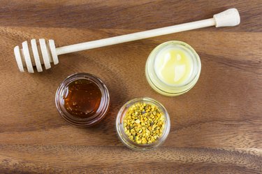 Raw organic bee pollen, royal jelly and honey in jar. Bee pollen granules. Apitherapy.