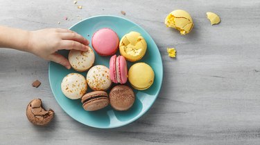 Colorful macaroons on a plate on a wooden table