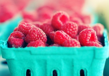 A container of red raspberries