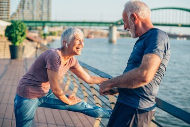 Senior couple stretching outdoors