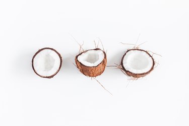 Fresh coconuts on white background. Flat lay, top view