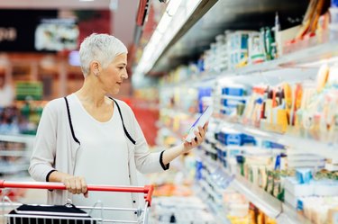 A woman over 50 grocery shopping for the best food for weight loss