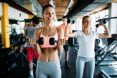 Group of healthy fitness people in gym