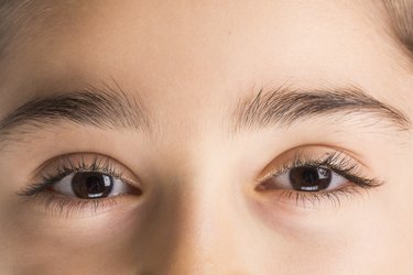 Close-up image of of brown eye and eyelashes