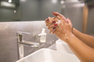 Business woman hand washing with soap to prevent Coronavirus