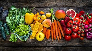 Healthy fresh rainbow colored fruits and vegetables in a row